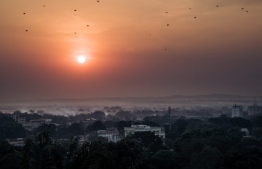 This photograph, taken on December 25, 2020, shows the city of Bangui, capital of the Central African Republic, at sunset. - Two days before the presidential and legislative elections, the security situation in the country is very tense, with rebels less than 100km from the capital. The coalition of armed groups that has been conducting a week-long offensive against several towns in the country decided to break their truce today and "resume its relentless march to its final objective", according to a statement confirmed to AFP by two major rebel groups. (Photo by ALEXIS HUGUET / AFP)