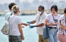 Airport staff offering hand sanitiser to tourists at Velana International Airport. Maldives recorded over 20,000 tourist arrivals during the first week of 2021. PHOTO: MIHAARU