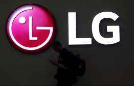 A man walks past an LG logo at the Mobile World Congress in Barcelona, Spain, February 27, 2018. PHOTO: REUTERS/ SERGIO PEREZ