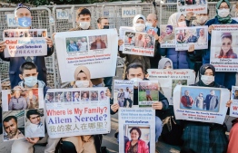 Members of the Muslim Uighur minority hold placards as they demonstrate in front of the Chinese consulate on December 30, 2020, in Istanbul, to ask for news of their relatives and to express their concern after China announced the ratification of an extradition treaty with Turkey. - The Chinese parliament ratified on December 26, 2020 an extradition treaty signed in 2017 with Ankara, a text that Beijing wants to use in particular to speed up the return of certain Muslim Uyghurs suspected of "terrorism" and who are refugees in Turkey. But the head of Turkish diplomacy said on December 30, 2020 that Ankara was not going to return Muslim Uyghurs to China, despite Beijing's ratification of an extradition treaty that worries the 50,000 members of this community who have taken refuge in the country. (Photo by BULENT KILIC / AFP)
