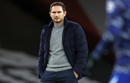 Chelsea's English head coach Frank Lampard watches warm up ahead of the English Premier League football match between Arsenal and Chelsea at the Emirates Stadium in London on December 26, 2020. (Photo by Adrian DENNIS / POOL / AFP) / RESTRICTED TO EDITORIAL USE. No use with unauthorized audio, video, data, fixture lists, club/league logos or 'live' services. Online in-match use limited to 120 images. An additional 40 images may be used in extra time. No video emulation. Social media in-match use limited to 120 images. An additional 40 images may be used in extra time. No use in betting publications, games or single club/league/player publications. / 