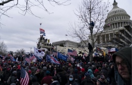 Supporters of US President Donald Trump protest outside the US Capitol on January 6, 2021, in Washington, DC. - Demonstrators breeched security and entered the Capitol as Congress debated the a 2020 presidential election Electoral Vote Certification. (Photo by ALEX EDELMAN / AFP)