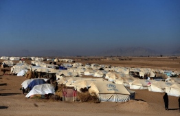 A general view shows tents at a camp for internally displaced families in Dand district of Kandahar province on January 7, 2021. - About 17,000 Afghan families from the Taliban bastion of Kandahar have fled their homes following months of heavy fighting between the insurgents and government forces despite peace talks, officials said (Photo by Javed TANVEER / AFP)