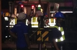 MNDF Fire & Rescue work to rescue the MPL staff trapped under the fallen glass pallet.