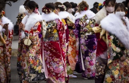 Twenty-year-old women dressed in kimonos gather outside Todoroki Arena during the "Coming-of-Age Day" celebration ceremony in Kawasaki, Kanagawa prefecture on January 11, 2021 under a state of emergency over the Covid-19 coronavirus pandemic. (Photo by Behrouz MEHRI / AFP)