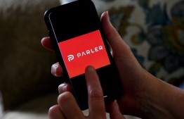 (FILES) This illustration file photo taken on July 2, 2020 shows social media application logo Parler displayed on a smartphone in Arlington, Virginia. - Apple on January 9, 2021, followed Google and removed the Parler app from its mobile store for allowing "threats of violence," after the deadly attack on the US Capitol by supporters of President Donald Trump. (Photo by Olivier DOULIERY / AFP)