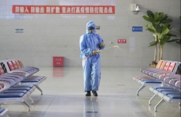 Staff member Liu Junhua disinfects the waiting hall of Suifenhe Railway Station in Suifenhe City, northeast China's Heilongjiang Province, April 30, 2020. PHOTO: XINHUA / ZHANG TAO