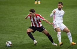 Athletic Bilbao's Spanish midfielder Unai Vencedor (L) vies with Real Madrid's Belgian forward Eden Hazard during the Spanish Super Cup semi final football match between Real Madrid and Athletic Club Bilbao at La Rosaleda stadium in Malaga on January 14, 2021. (Photo by JORGE GUERRERO / AFP)
