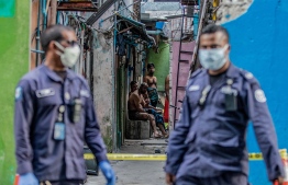 Security personnel patrol as Bangladeshi workers (C) living in the accommodation block are put under quarantine after positive cases of COVID-19 coronavirus were found in the area, in Male on May 9, 2020. (Photo by Ahmed SHURAU / AFP) (Photo by AHMED SHURAU/AFP via Getty Images)