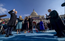 Joe Biden (L) is sworn in as the 46th president of the United States by Chief Justice John Roberts (L) as Jill Biden holds the Bible, alongside son Hunter Biden and daughter of Joe and Jill Biden Ashley Biden, during the 59th Presidential Inauguration on January 20, 2021, at the US Capitol in Washington, DC. (Photo by Andrew Harnik / POOL / AFP)