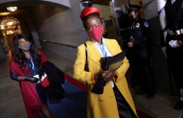 National youth poet laureate Amanda Gorman arrives at the inauguration of US President-elect Joe Biden on the West Front of the US Capitol on January 20, 2021 in Washington, DC. (Photo by Win McNamee / POOL / AFP)