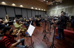 Musicians of the Teatro Real's main orchestra rehearse at the Teatro Real in Madrid on January 14, 2021. (Photo by OSCAR DEL POZO / AFP)