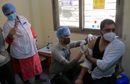 A health worker inoculates a doctor with Covid-19 coronavirus vaccine at the BAPS Yogiji Maharaj Hospital in Ahmedabad on January 22, 2021. PHOTO: SAM PANTHAKY / AFP