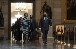 Clerk of the House Cheryl Johnson along with acting House Sergeant-at-Arms Tim Blodgett, right, and Rep. Jamie Raskin, D-Md., lead the Democratic House impeachment managers as they walk through Statuary Hall on Capitol Hill to deliver to the Senate the article of impeachment alleging incitement of insurrection against former President Donald Trump, in Washington, Monday, Jan. 25, 2021. (AP Photo/J. Scott Applewhite, Pool)