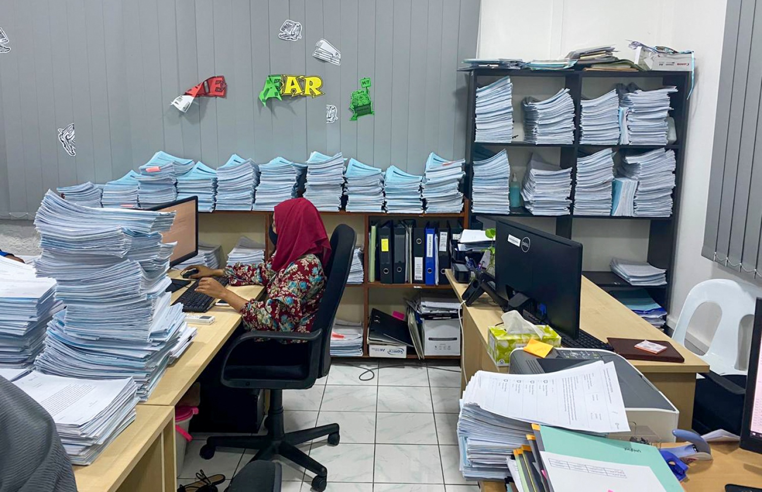 ކުރީ ސަރުކާރުން އުފެއްދި ފްލެޓް ކޮމިޓީގެ މުވައްޒަފަކު މަސައްކަތުގައި. ހައުސިން ޕްރޮޖެކްޓްތަކަށް ހުޅުވާލުން އެތައް ހާސް މީހުނެއް ކޮންމެ ފަހަރު ވެސް ކުރިމަތިލާ -- ފޮޓޯ: މިހާރު