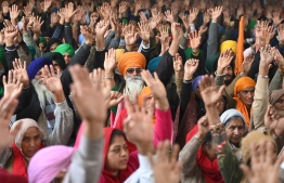 Protesting farmers listens to a speaker at the Delhi-Haryana state border in Singhu on January 27, 2021 as they continue to demonstrate against the central government’s recent agricultural reforms.