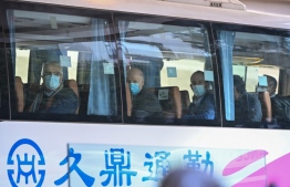 Members of the World Health Organization (WHO) team investigating the origins of the Covid-19 coronavirus pandemic leave The Jade Hotel on a bus after completing their quarantine in Wuhan, China’s central Hubei province on January 28, 2021. 
Hector RETAMAL / AFP
