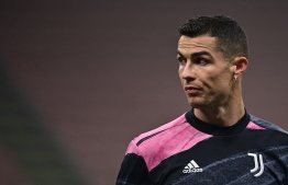 Juventus' Portuguese forward Cristiano Ronaldo looks on as he warms up prior to the Italian Cup semifinal first leg football match beetween Inter Milan and Juventus Turin on February 2, 2021 at the San Siro stadium in Milan. (Photo by MIGUEL MEDINA / AFP)