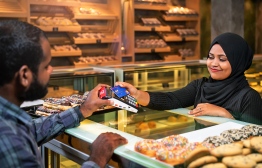 A BML cardholder makes a purchase at a cafe'.. PHOTO: BML