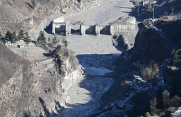 A general view shows the remains of a dam along a river in Tapovan of Chamoli district on February 8, 2021 damaged after a flash flood thought to have been caused when a glacier broke off on February 7.
Sajjad HUSSAIN / AFP