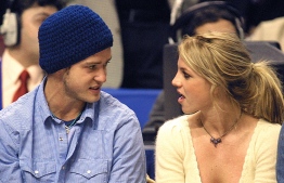 (FILES) In this file photo taken on February 09, 2002 Pop superstars Britney Spears (R) and boyfriend Justin Timberlake (L) talk as they sit courtside at the NBA All-Star Game in Philadelphia. - Justin Timberlake on February 12, 2021 apologized for moments he "fell short" and condoned misogyny, one week after the release of a blockbuster documentary on Britney Spears saw the behavior of the former boy band star come under sharp criticism.
The film, produced by FX and The New York Times, explores the vitriol both the media and entertainment industry aimed at Spears, who soared to global fame before publicly suffering a mental health crisis and becoming a paparazzi punching bag in the mid-to-late 2000s. (Photo by TOM MIHALEK / AFP)