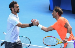 Spain's Rafael Nadal (R) shakes hands with Italy's Fabio Fognini after victory during their men's singles match on day eight of the Australian Open tennis tournament in Melbourne on February 15, 2021. (Photo by William WEST / AFP) /