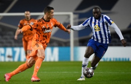 Juventus' Portuguese forward Cristiano Ronaldo (L) vies with FC Porto's Malian forward Moussa Marega during the UEFA Champions League round of 16 first leg football match between Porto and Juventus at the Dragao stadium in Porto on February 17, 2021. (Photo by MIGUEL RIOPA / AFP)