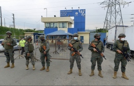Members of the Ecuadorian Marine Force guard the Zone 8 Deprivation of Liberty Center in Guayaquil, Ecuador, on February 23, 2021. - At least 50 inmates died in riots at three prisons in Ecuador on Tuesday, police said. (Photo by Marcos Pin Mendez / AFP)