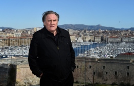 (FILES) In this file photo taken on February 18, 2018, French actor Gerard Depardieu poses during a photocall for the second season of the French TV show "Marseille" broadcasted and co-produced by US streaming video giant Netflix in Marseille, southern France. - French actor Gerard Depardieu has been charged with rape and sexual assault allegedly committed in 2018 against an actress in her 20s, a judicial source told AFP on February 23, 2021. A first probe of the rape accusations against Depardieu, 72, was dropped for lack of evidence but later reopened, leading to criminal charges filed in December, the source said. (Photo by ANNE-CHRISTINE POUJOULAT / AFP)