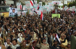 Supporters of the Yemeni Huthi rebels raise placards during a  protest against the blockade imposed on their country by the Saudi coalition,in the capital Sanaa, on February 26, 2021.
The writing on the placards reads in Arabic: "God is gear, death to America and Israel, curse on the Jews, victory to Islam'. - Yemen's Iran-backed Huthi rebels claimed on February 28, the attempted strikes that targeted the Saudi Arabian capital Riyadh and other regions overnight, threatening more attacks.
They have intensified operations against the kingdom amid increased bloody clashes to seize the Saudi-backed Yemeni government's last northern stronghold of Marib. (Photo by Mohammed HUWAIS / AFP)