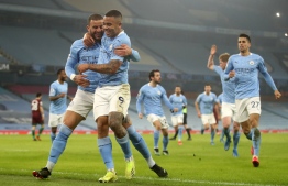 Manchester City's Brazilian striker Gabriel Jesus (2L) celebrates scoring his team's second goal during the English Premier League football match between Manchester City and Wolverhamptom Wanderers at the Etihad Stadium in Manchester, north west England, on March 2, 2021. (Photo by CARL RECINE / POOL / AFP) / RESTRICTED TO EDITORIAL USE. No use with unauthorized audio, video, data, fixture lists, club/league logos or 'live' services. Online in-match use limited to 120 images. An additional 40 images may be used in extra time. No video emulation. Social media in-match use limited to 120 images. An additional 40 images may be used in extra time. No use in betting publications, games or single club/league/player publications. / 