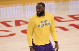(FILES) In this file photo taken on February 26, 2021 LeBron James #23 of the Los Angeles Lakers smiles as he warms up before the game against the Portland Trail Blazers at Staples Center in Los Angeles, California. - Four-time NBA champion LeBron James hit back at Swedish soccer star Zlatan Ibrahimovic on February 26, 2021, saying there is no reason why he cannot have just as big an impact off the basketball court as he does on it. (Photo by Harry How / GETTY IMAGES NORTH AMERICA / AFP)