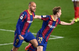 Barcelona's Danish forward Martin Braithwaite (L) celebrates scoring his team's third goal during Spanish Copa del Rey (King's Cup) semi-final second leg football match between FC Barcelona and Sevilla FC at the Camp Nou stadium in Barcelona on March 3, 2021. (Photo by Josep LAGO / AFP)