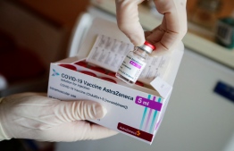 (FILES) In this file photo taken on March 03, 2021 a nurse shows a package of the Astrazeneca coronavirus (Covid-19) vaccine at a doctor's surgery in Senftenberg, Brandenburg, eastern Germany,where the first vaccinations are given in doctors' surgeries. - Germany's vaccine commission on Thursday approved the AstraZeneca/Oxford Covid-19 vaccine for people over 65 following the publication of new data from the UK. (Photo by HANNIBAL HANSCHKE / POOL / AFP)