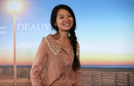 (FILES) In this file photo taken on September 5, 2015 US-Chinese director Chloe Zhao poses during a photocall to present the movie "Songs My Brothers Taught Me" in the French northwestern sea resort of Deauville, during the 41th Deauville US Film Festival. - "Nomadland" made Golden Globes history on February 28, 2021 as Chloe Zhao became the first female director to win the awards' top prize for best drama, putting her film about marginalized Americans roaming the West in vans into Oscars pole position. (Photo by Charly TRIBALLEAU / AFP)