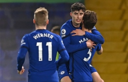 Chelsea's German midfielder Kai Havertz (C) celebrates with teammates after his shot is deflected into the net by Everton's English midfielder Ben Godfrey for an own goal during the English Premier League football match between Chelsea and Everton at Stamford Bridge in London on March 8, 2021. (Photo by Glyn KIRK / POOL / AFP) / RESTRICTED TO EDITORIAL USE. No use with unauthorized audio, video, data, fixture lists, club/league logos or 'live' services. Online in-match use limited to 120 images. An additional 40 images may be used in extra time. No video emulation. Social media in-match use limited to 120 images. An additional 40 images may be used in extra time. No use in betting publications, games or single club/league/player publications. / 