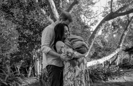 This undated image released by photographer Misan Harriman (@misanharriman) via Instagram on March 8, 2021 shows Prince Harry and his wife Meghan Markle, the Duke and Duchess of Sussex, posing with son Archie. - Britain's Prince Harry and wife Meghan Markle disclosed the gender of their second baby, a girl due later this year, during an interview with Oprah which aired on March 7. (Photo by Misan HARRIMAN / Misan Harriman via Instagram / AFP) / RESTRICTED TO EDITORIAL USE - MANDATORY CREDIT "AFP PHOTO / THE DUKE AND DUCHESS OF SUSSEX / MISAN HARRIMAN " - NO MARKETING NO ADVERTISING CAMPAIGNS - DISTRIBUTED AS A SERVICE TO CLIENTS --- NO ARCHIVE ---