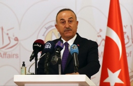 Turkish Foreign Minister Mevlut Cavusoglu attends a joint press conference following a tripartite meeting with his Russian and Qatari counterparts, on March 11, 2021 in Doha. (Photo by KARIM JAAFAR / AFP)