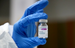 A medical worker holds a vial of the AstraZeneca Covid-19 vaccine at a school gym in Tirana on March 13, 2021: Maldives received a shipment of AstraZeneca vaccines last week --  Photo: Gent Shkullaku/ AFP