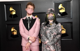 In this handout photo courtesy of The Recording Academy, US singer-songwriters Billie Eilish and Finneas attend the 63rd Annual Grammy Awards at Los Angeles Convention Center in Los Angeles on March 14, 2021. (Photo by Kevin Mazur / The Recording Academy / AFP) /