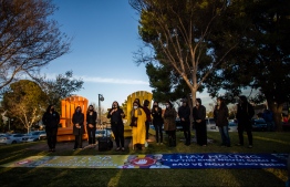 People gather for a candlelight vigil in Garden Grove, California, on March 17, 2021 to unite against the recent spate of violence targeting Asians and to express grief and outrage after yesterday's shooting that left eight people dead in Atlanta, Georgia, including at least six Asian women. - Police have said suspect Robert Aaron Long, a 21-year-old white man, has so far denied a racist motive for the three shootings in the southern US state of Georgia. (Photo by Apu GOMES / AFP)