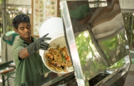 Individual discards food waste into the Power Knot LFC Bio-Digester. PHOTO: HOTELIER MALDIVES