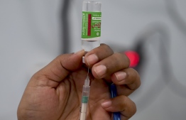 A medical staff fills a syringe with the Covishield vaccine before inoculating a beneficiary as part of the nationwide Covid-19 coronavirus vaccination drive at the Rajawadi hospital in Mumbai on March 17, 2021. (Photo by INDRANIL MUKHERJEE / AFP)