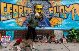 (FILE)Paul, a volunteer, cleans "George Floyd Square" the place where George Floyd was murdered in May 2020, on March 28, 2021 in Minneapolis, Minnesota. - Over 56 percent of the voters in Minneapolis rejected replacing the city's police force on Tuesday, November 2, 2021 --Photo: Kerem Yucel / AFP