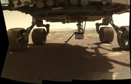 This NASA photo obtained on March 31, 2021 shows NASA’s Ingenuity Mars Helicopter as it extends vertically into place after being rotated outward from its horizontal position on the belly of the Perseverance rover on March 29, 2021, the 38th Martian day, or sol, of the mission. This image was taken by the WATSON (Wide Angle Topographic Sensor for Operations and eNgineering) camera on the SHERLOC (Scanning Habitable Environments with Raman and Luminescence for Organics and Chemicals) instrument, located at the end of the rover’s long robotic arm.
Handout / NASA/JPL-CALTECH / AFP