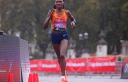 Kenya's Ruth Chepngetich sliced almost half a minute off the previous best mark of 1hr 4:31 JOHN SIBLEY POOL/AFP