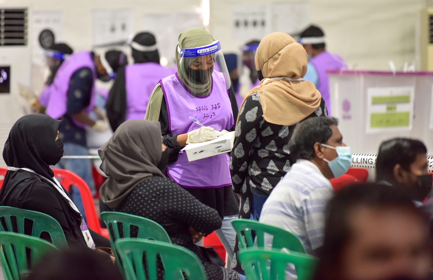 މާލެ: އޭޕްރިލް 10، 2021: މާލޭގައި ބަހައްޓާފައިވާ ވޯޓުފޮއްޓަކަށް ވޯޓުލާން ދިޔަ މީހެއްގެ މައުލޫމާތު ޗެކް ކުރަނީ.---ފޮޓޯ: ނިޝާން އަލީ/މިހާރު