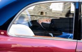 Britain's Queen Elizabeth II travels in the State Bentley during the ceremonial funeral procession of Britain's Prince Philip, Duke of Edinburgh to St George's Chapel in Windsor Castle in Windsor, west of London, on April 17, 2021. - Philip, who was married to Queen Elizabeth II for 73 years, died on April 9 aged 99 just weeks after a month-long stay in hospital for treatment to a heart condition and an infection. (Photo by LEON NEAL / various sources / AFP)