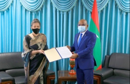 The representative of WHO to Maldives Dr Nazneen Anwar presents her Letter of Appointment to Foreign Minister Shahid. PHOTO: FOREIGN MINISTRY
