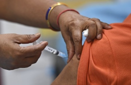 A medical worker inoculates a man with the Covaxin Covid-19 coronavirus vaccine, at a health centre in New Delhi on April 29, 2021. (Photo by TAUSEEF MUSTAFA / AFP)